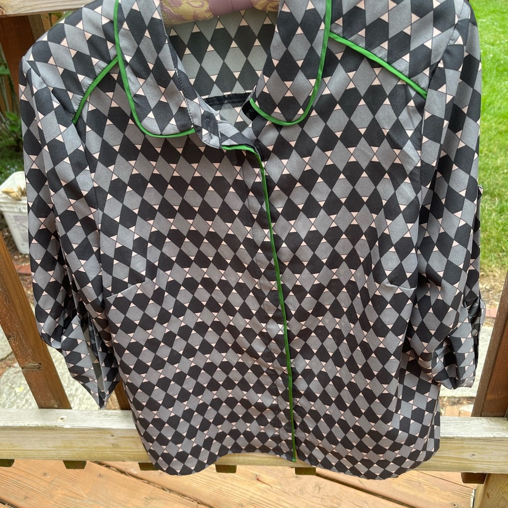 Gray and black blouse with green piping.